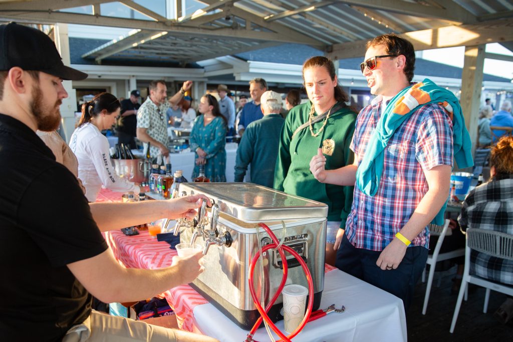 Oceanic Wrightsville Beach NC Annual Oyster Roast 2024 - Beers on tap with customers in line